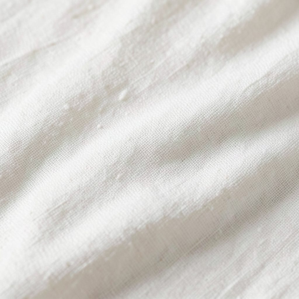Pale unbleached fabric texture in natural light